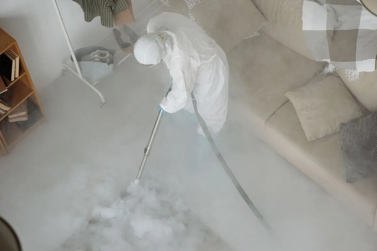 Biohazard cleanup technician in protective equipment, Orchard Homes, MT